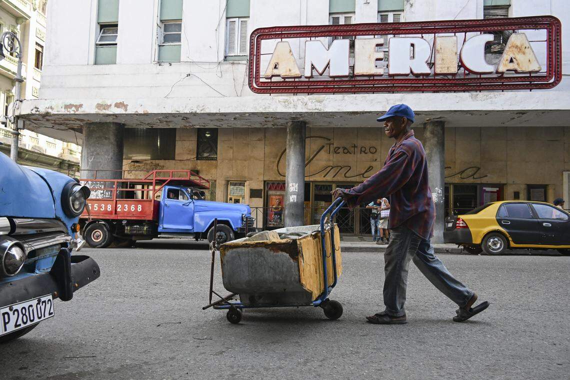 A recyclable materials collector pushes a cart in front of the America Theater in Havana on March 13, 2026. Cuba's President Miguel Diaz-Canel confirmed on March 13, 2026 that "Cuban officials have recently held talks" with representatives of the United States, amid heightened tensions between Washington and Havana. 