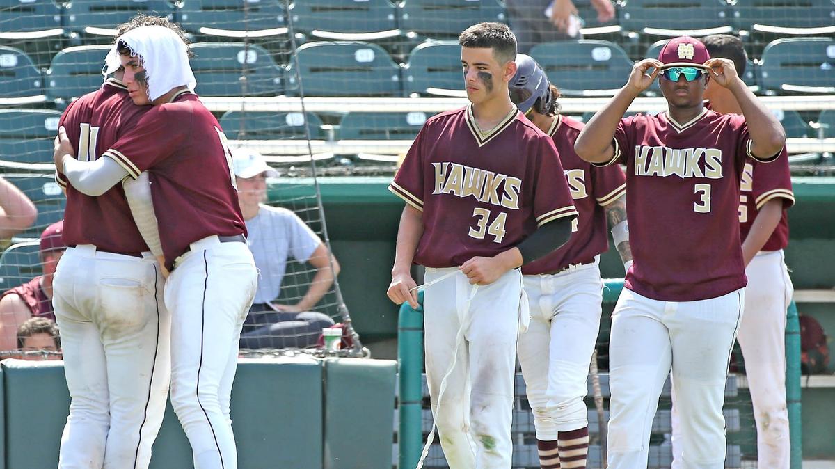 Miami Springs HS Jason Torres (11) walks away from home plate and gets a hug from Anthony Nunez (16) as they are defeated by Jesuit School in the FHSAA Semi-Final Class 6A Division at CenturyLink Sports Complex - Hammond Stadium in Fort Myers, Florida, Friday, May, 31, 2019.