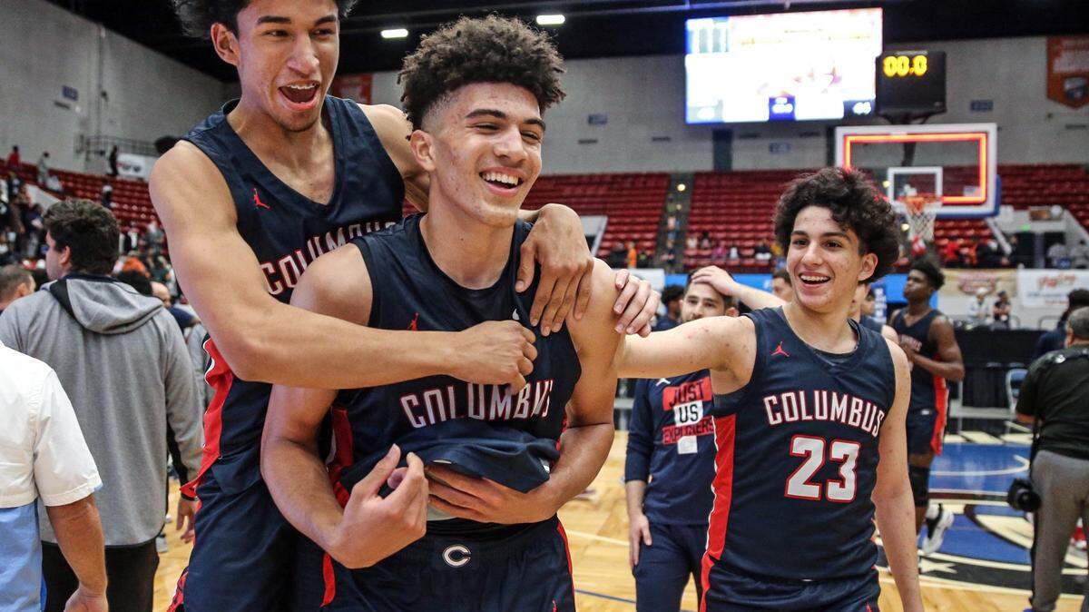 Columbus  Jalen Velasquez Diaz (1), guard Cameron Boozer (12) and Benny Fragela (23) celebrate after defeating Dr. Phillips 45-44 in the Florida High School Athletic Association Class 7A boys basketball state championship at the RP Funding Center in Lakeland on Saturday, March 5, 2022.
