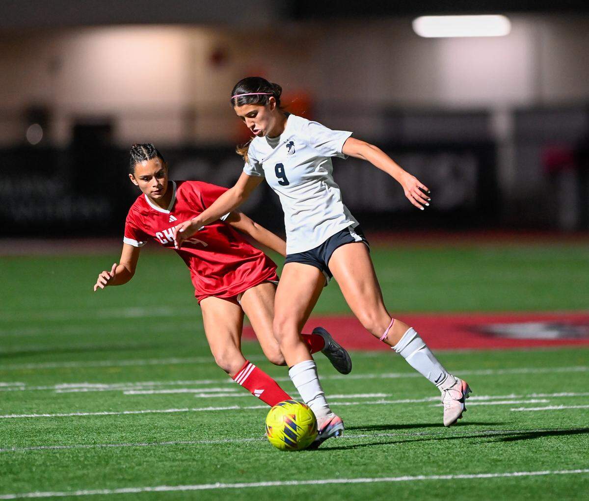 La Salle’s Camila Andreu (right) dribbles the ball past a Cardinal Gibbons defender during Friday’s Region 4-3A girls’ soccer final at Cardinal Gibbons High in Fort Lauderdale.