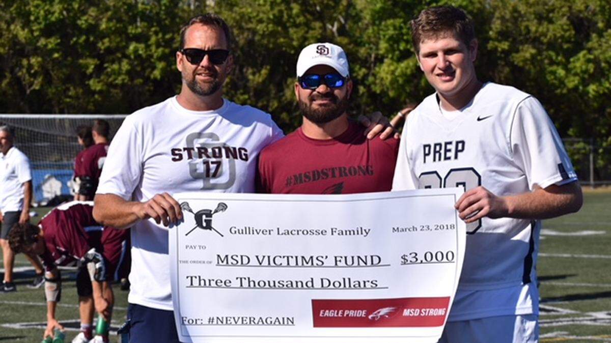 Gulliver Prep varsity lacrosse players sold T-shirts before their game with Marjory Stoneman Douglas High School to show solidarity and support. From left, Gulliver Coach Jim Piggot, MSD Coach Ryan Burton, and Gulliver junior and lacrosse player Scott Hellinger, who organized the fundraiser.