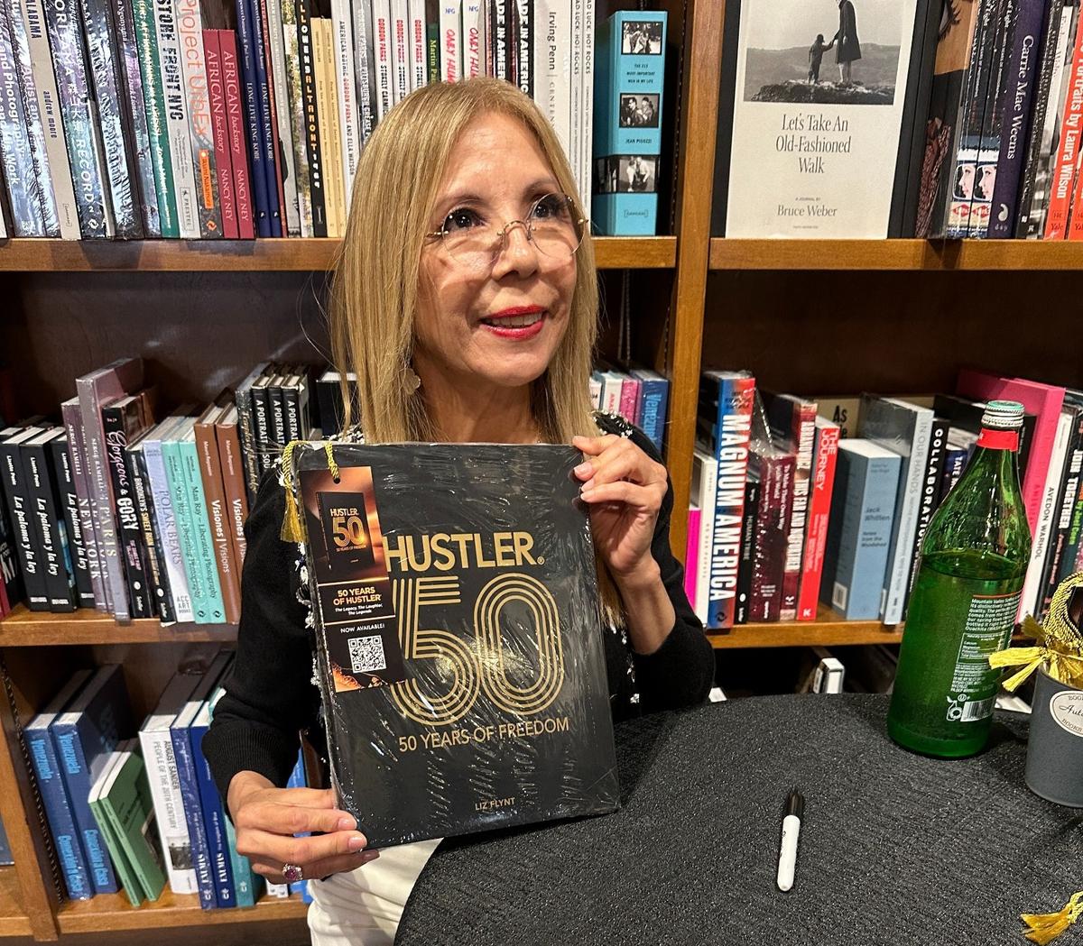 Liz Flynt, widow of Hustler magazine founder and publisher Larry Flynt and chairwoman of Hustler, signs copies of her recently published coffeetable book, “Hustler: 50 Years of Freedom,” at Coral Gables’ Books & Books on June 7, 2025.