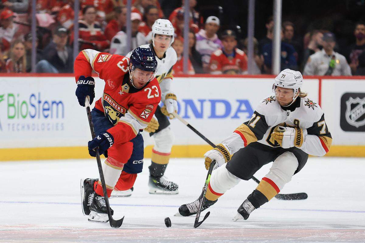 SUNRISE, FLORIDA - OCTOBER 25: Carter Verhaeghe #23 of the Florida Panthers and William Karlsson #71 of the Vegas Golden Knights compete for the puck during the first period of the game at Amerant Bank Arena on October 25, 2025 in Sunrise, Florida. (Photo by Megan Briggs/Getty Images)