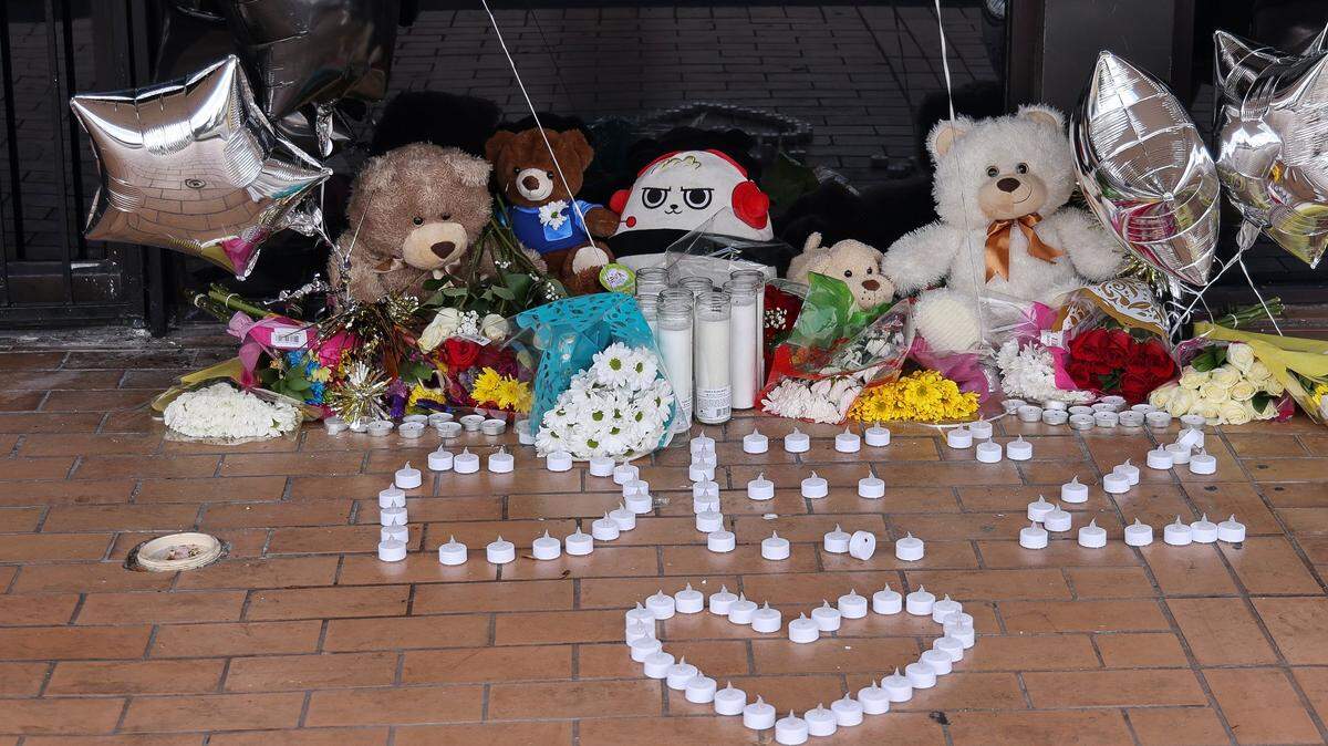 A makeshift memorial for the victims of early Sunday morning mass shooting containing flowers, stuff animals, candles, photos, and messages is placed at the bullet riddled front door of the banquet hall on Tuesday, June 1, 2021 in unincorporated northwest Miami-Dade county.