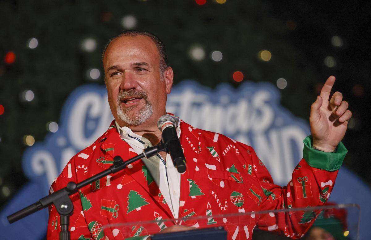 Tony Albelo, president of Loud And Live, speaks to visitors at Christmas Wonderland at Tropical Park, a Miami-style holiday celebration of flavor and culture in Miami, Florida on Thursday, November 13, 2025.