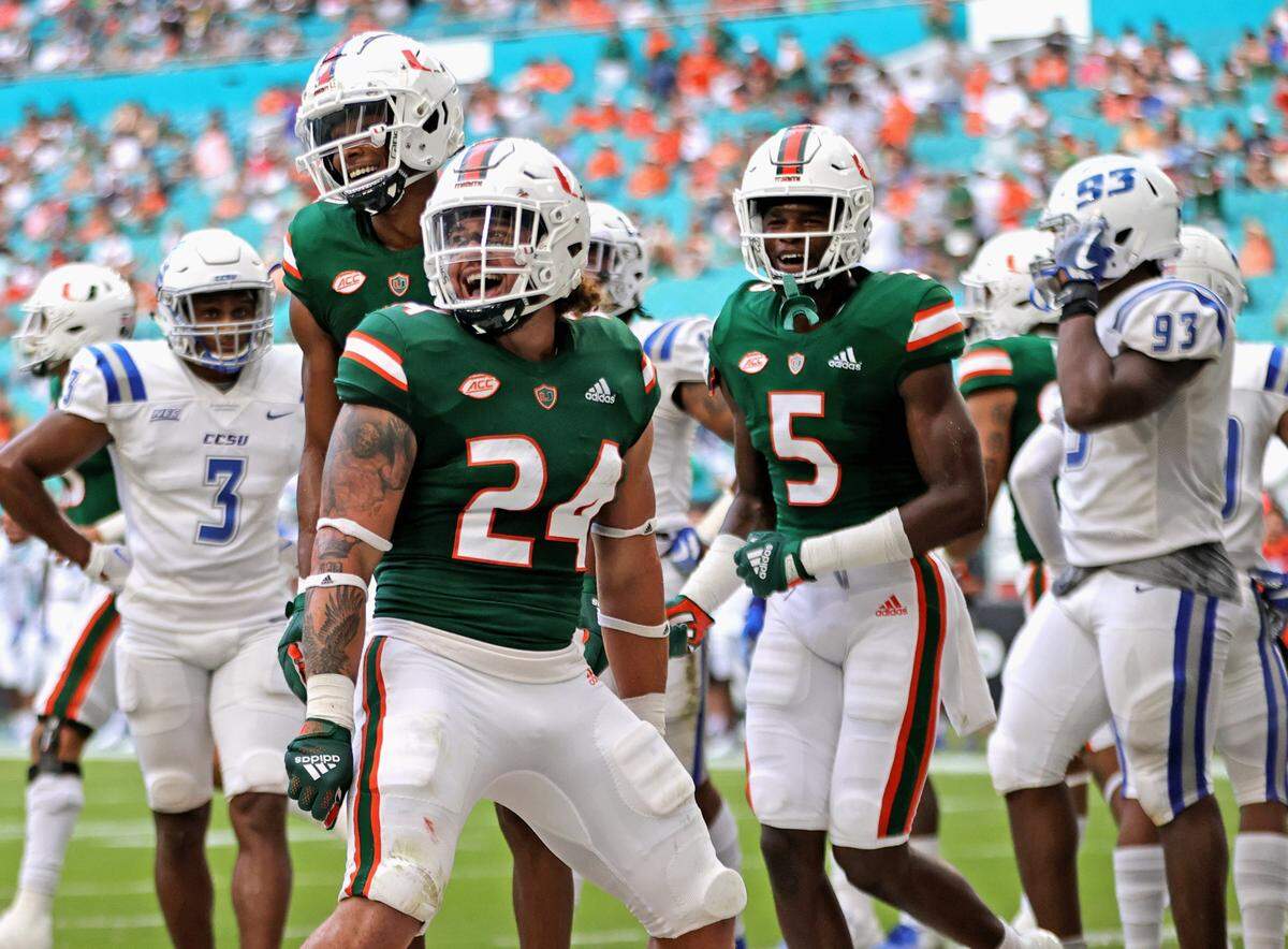 Miami Hurricanes running back Cody Brown (24) celebrate with teammates after scoring a touchdown during the first quarter of their ACC football game against the Central Connecticut State Blue Devils at Hard Rock Stadium on Saturday, September 25, 2021 in Miami Gardens, Florida.