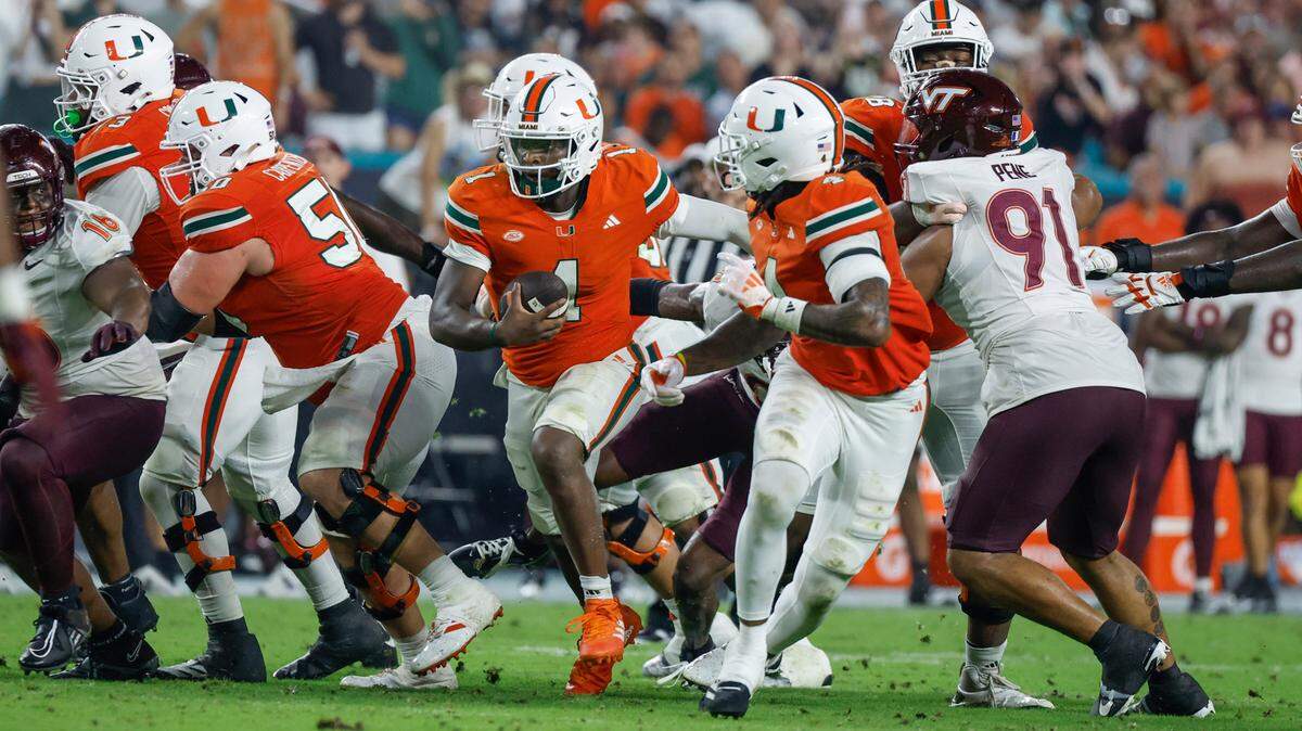 Miami Hurricanes Cam Ward (1) on a quarterback keeper to score against the Virginia Tech Hokies in the second half of an ACC conference football game at Hard Rock Stadium on Friday, September 27, 2024, in Miami Gardens, Fla.