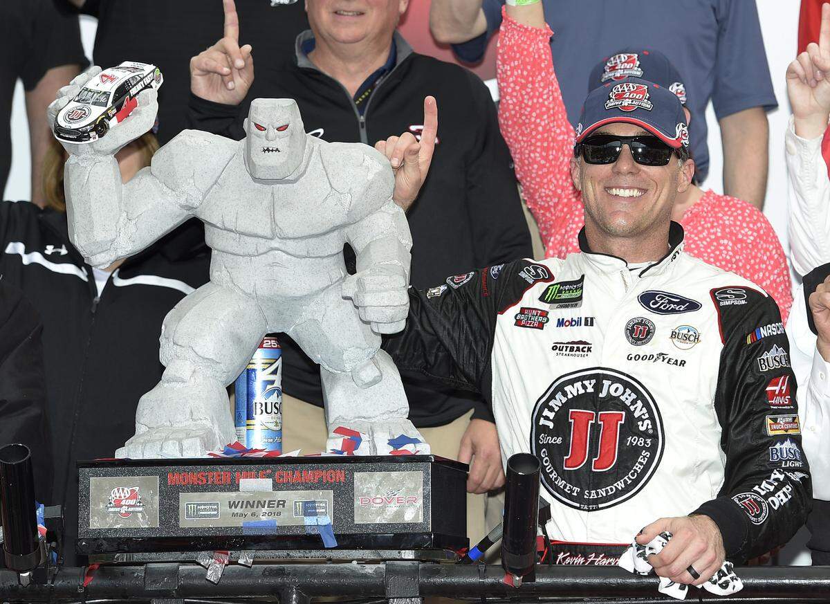 Kevin Harvick, right, poses with the trophy in Victory Lane after he won the NASCAR Cup Series auto race, Sunday, May 6, 2018, at Dover International Speedway in Dover, Del. (AP Photo/Nick Wass)