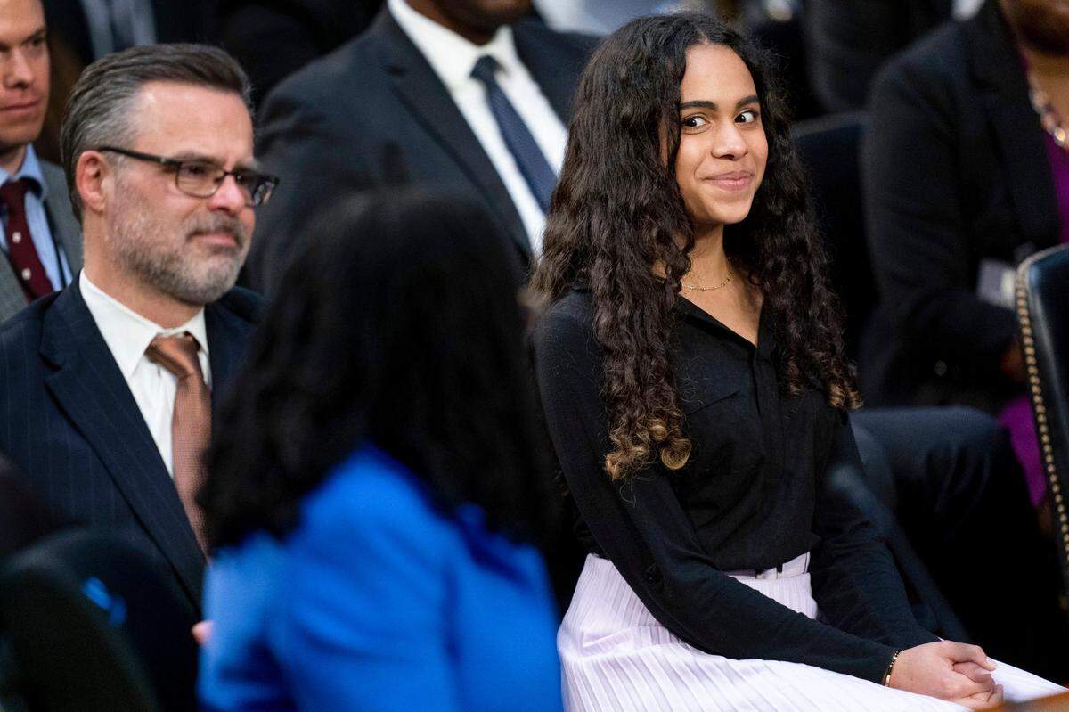 Leila Jackson, right, reacts as Chairman Sen. Dick Durbin, D-Ill., speaks to her as her mother, Supreme Court nominee Ketanji Brown Jackson, foreground, finishes up her Senate Judiciary Committee confirmation hearing on Capitol Hill in Washington, Wednesday, March 23, 2022. Also pictured is Dr. Patrick Jackson, left.