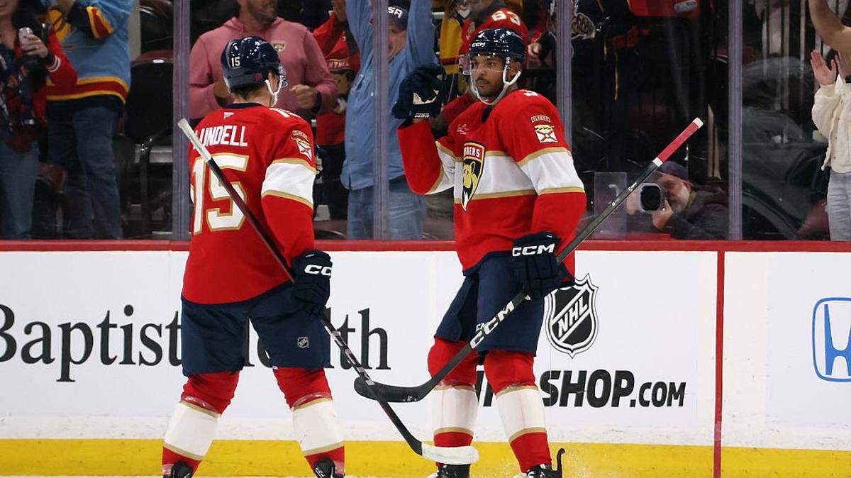 SUNRISE, FLORIDA - NOVEMBER 17: Seth Jones #3 of the Florida Panthers (r) celebrates his first period powerplay goal against the Vancouver Canucks and is joined by Anton Lundell #15 at Amerant Bank Arena on November 17, 2025 in Sunrise, Florida. (Photo by Bruce Bennett/Getty Images)