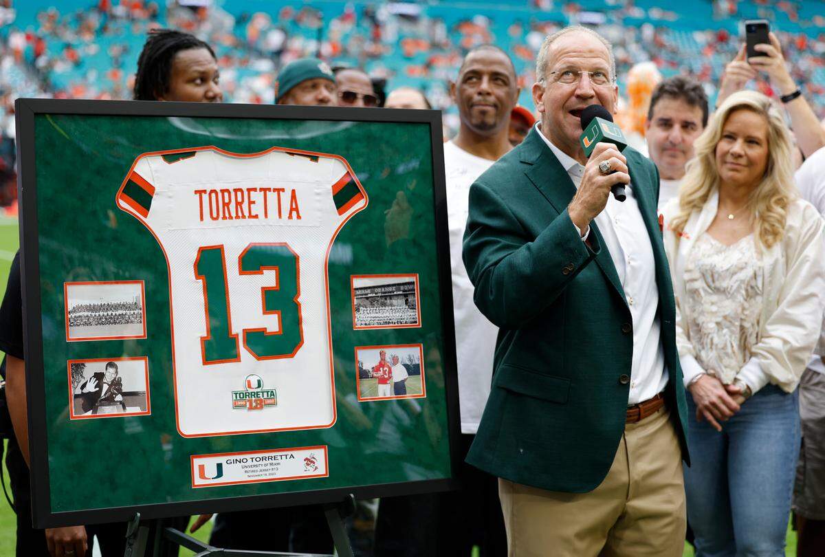 Former Miami Hurricanes quarterback Gino Torretta is presented with his retired jersey number 13 at halftime during the game against the Louisville Cardinals on Saturday, November 18, 2023.