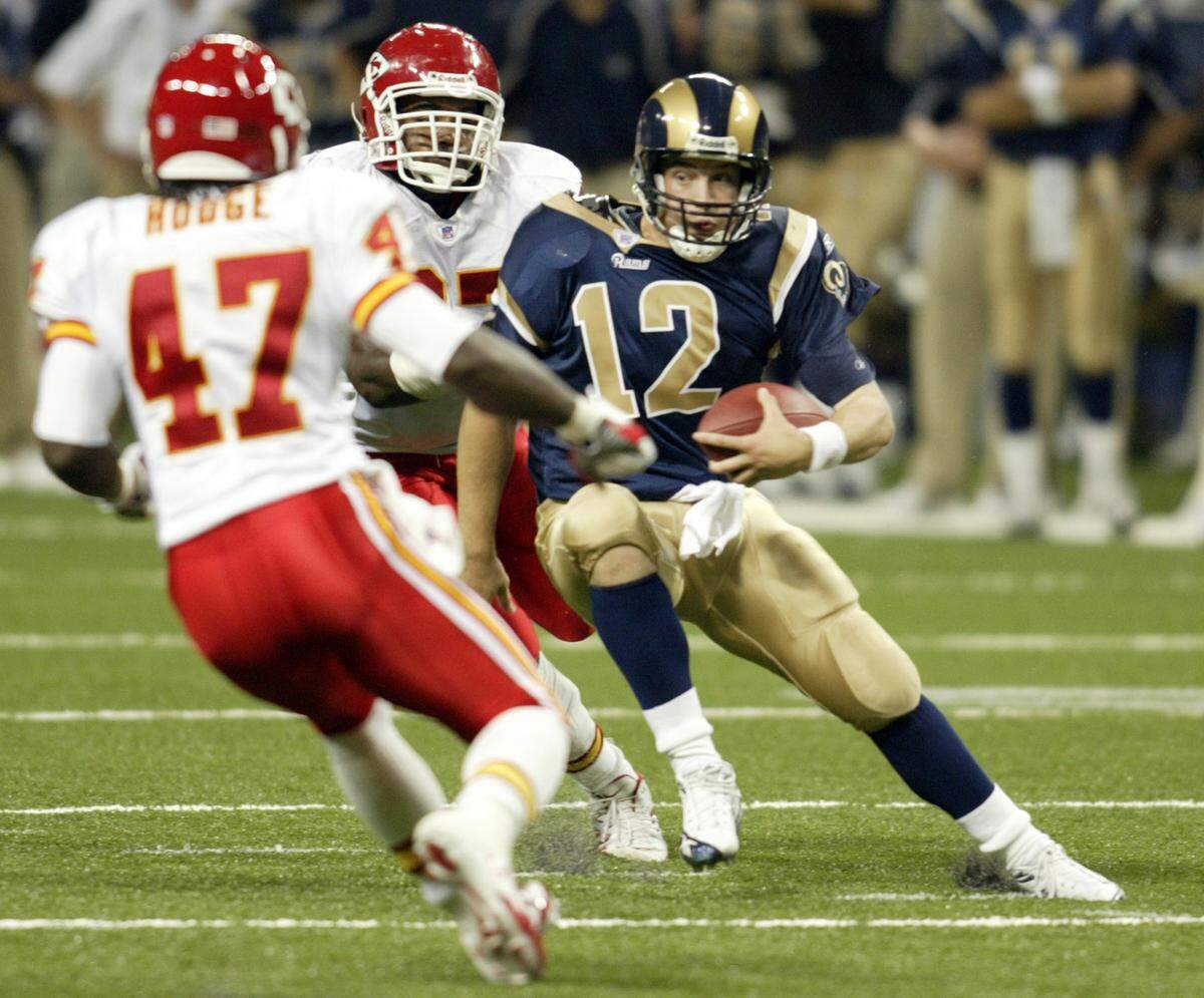 St. Louis Rams’ Ryan Fitzpatrick scrambles as Kansas City Chiefs’ Alphonso Hodge (47) and Keyaron Fox (97) chase him down in the third quarter of a preseason game Friday, Sept. 2, 2005, in St. Louis.