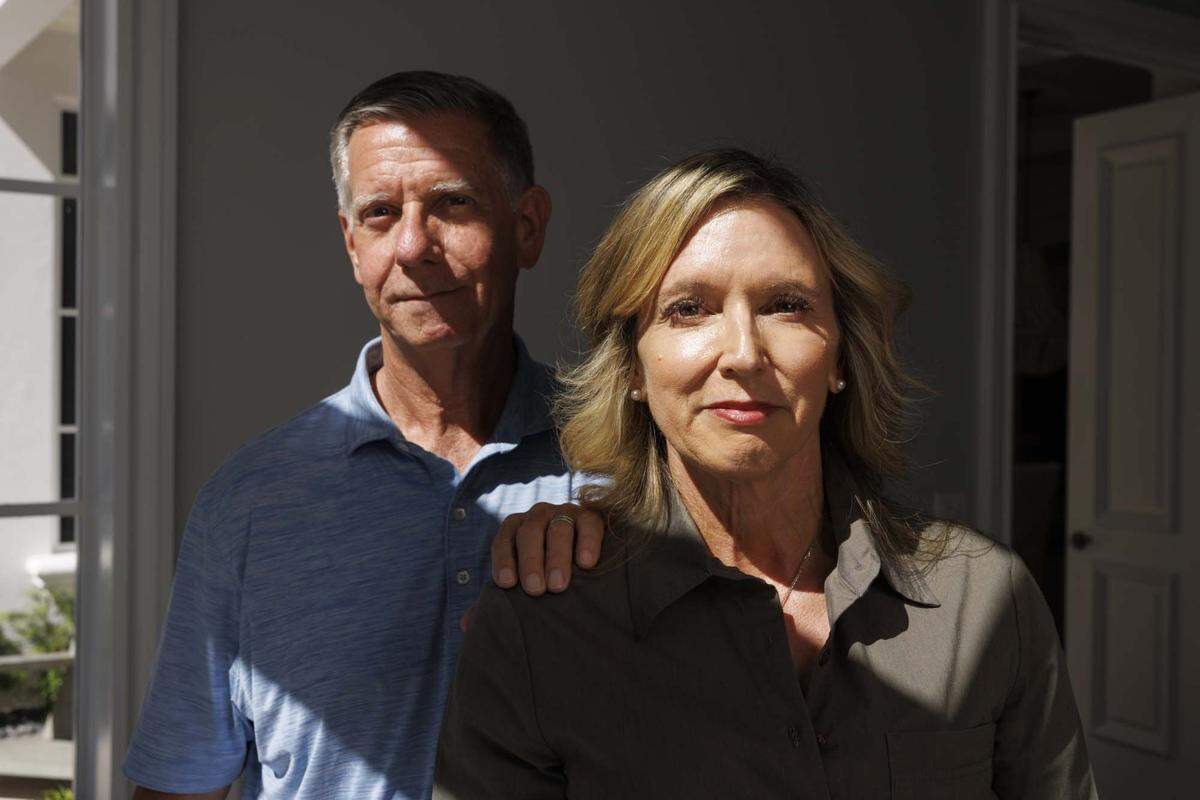 Parents Anne Davies-Vicino, right, and Frank Vicino pose in their home on Thursday, May 21, 2026, in Boca Raton, Fla. They now have to take their son, Andrew Vicino, to different hospitals across South Florida to care for his rare genetic condition because Joe DiMaggio Children's Hospital, which had all of his doctors in one place, is no longer in-network with Florida Blue due to ongoing contract disputes.