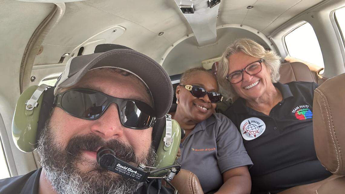 Bryan Stern, who leads the nonprofit group Project Dynamo, takes a photo with two Florida-based missionaries, Linotte Joseph (left) and Miriam Cinotti (right), while being rescued from Haiti.