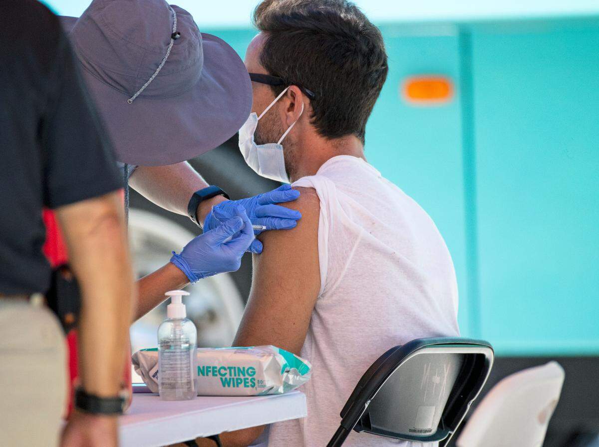 In early May, a dose of the single-shot Johnson & Johnson vaccine is administered at a pop-up vaccination site located at 16th Street and the beach in Miami Beach.