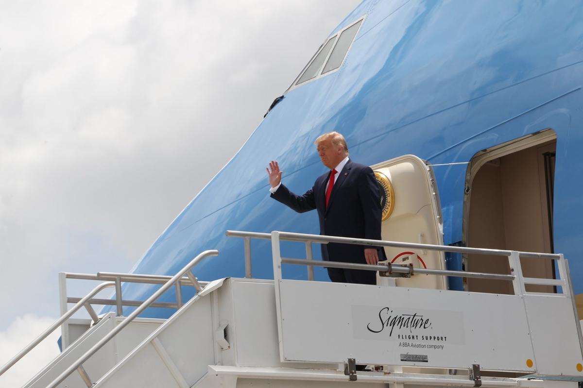 U.S. President Donald J. Trump waves as he exits Air Force One at Miami International Airport where he arrived for a visit to the U.S. Southern Command and a meeting with the Venezuelan exile community in Doral on Friday, July 10, 2020.