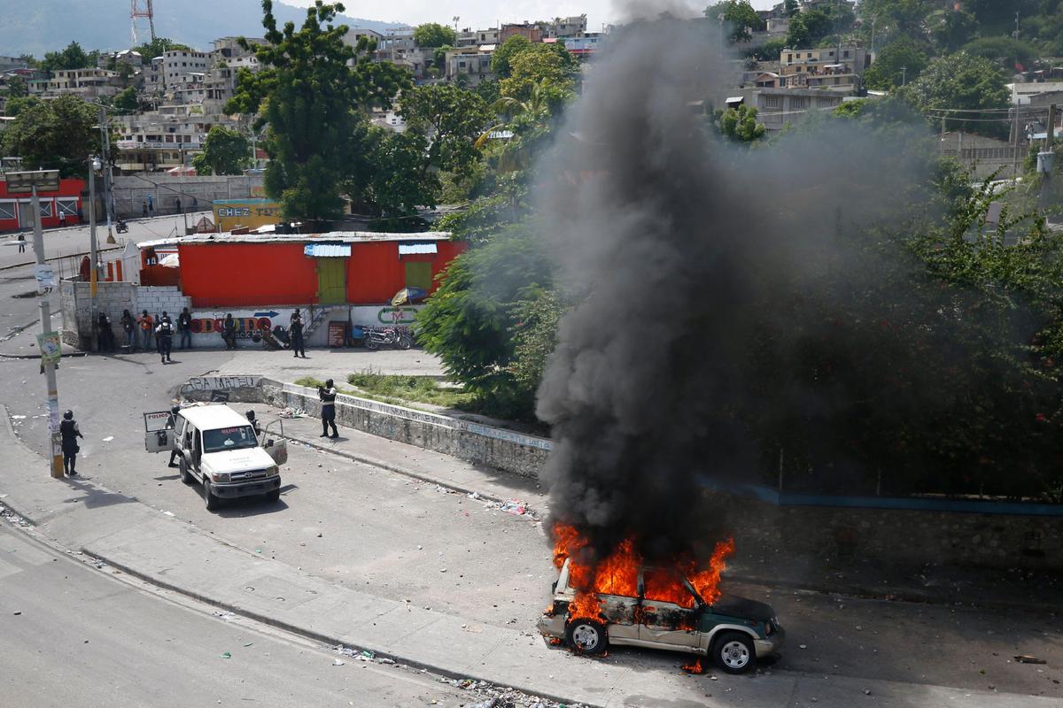 A vehicle goes up in flames during a nationwide push to block streets and paralyze the country’s economy as protesters press for President Jovenel Moise to give up power, in Port-au-Prince, Haiti, Monday, Sept. 30, 2019. 
