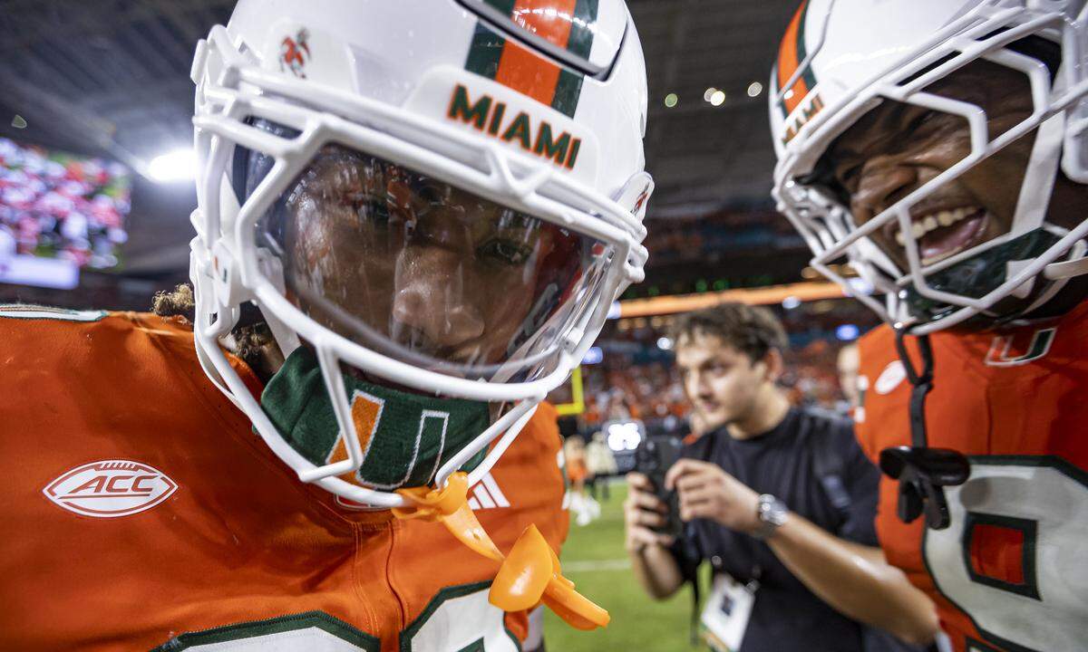Miami Hurricanes linebackers Kellen Wiley Jr. (30) and Malik Bryant (9) celebrate after they defeated the Notre Dame Fighting Irish in their NCAA football game at Hard Rock Stadium on Sunday, Aug. 31, 2025, in Miami Gardens, Fla.