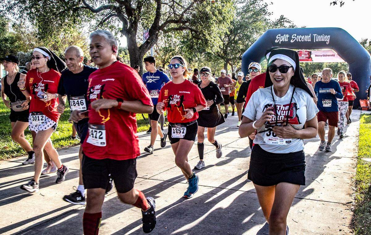 Runners including Rebecca Lee (wearing a nun’s habit), leave the starting line at the Barry University 5K/8K Nun Run on Saturday April 9, 2022.