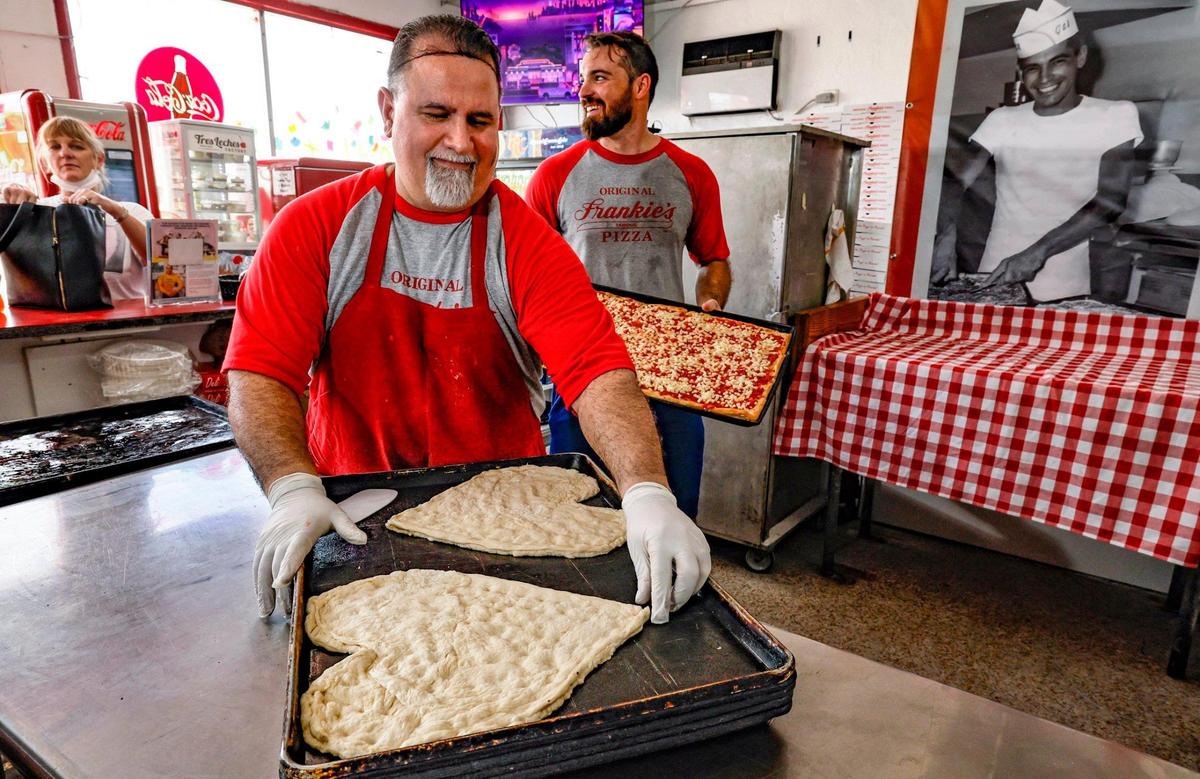 Master baker Jose Corrales, an employee at Frankie’s for 33 years, prepares heart-shaped pies for a Valentine’s Day anniversary celebration. To his right is a photograph of original owner Frank Pasquarella.