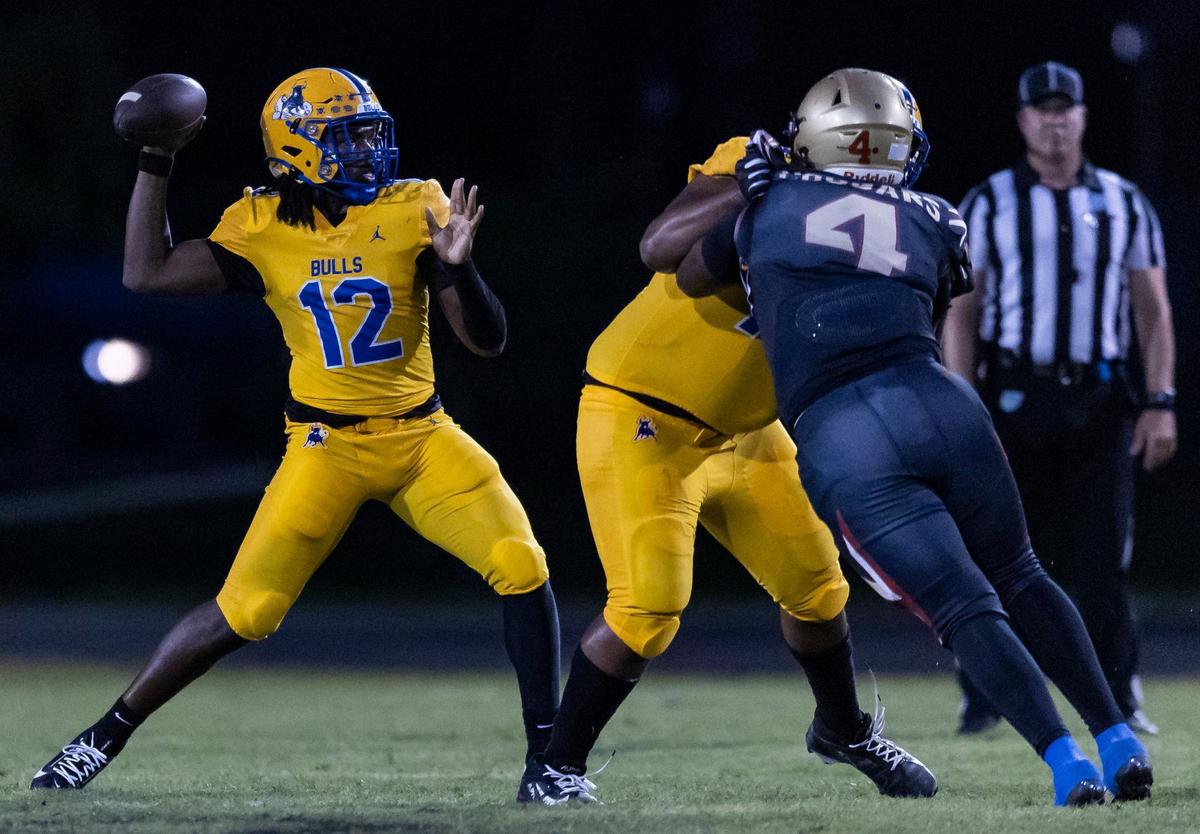 Miami Northwestern Bulls quarter Leon Strawder (12) looks to throw the ball as Coconut Creek Cougars linebacker Nimari Brantley (4) defends in the first half of their football game at Coconut Creek High School on Thursday, Aug. 22, 2024, in Coconut Creek, Fla.