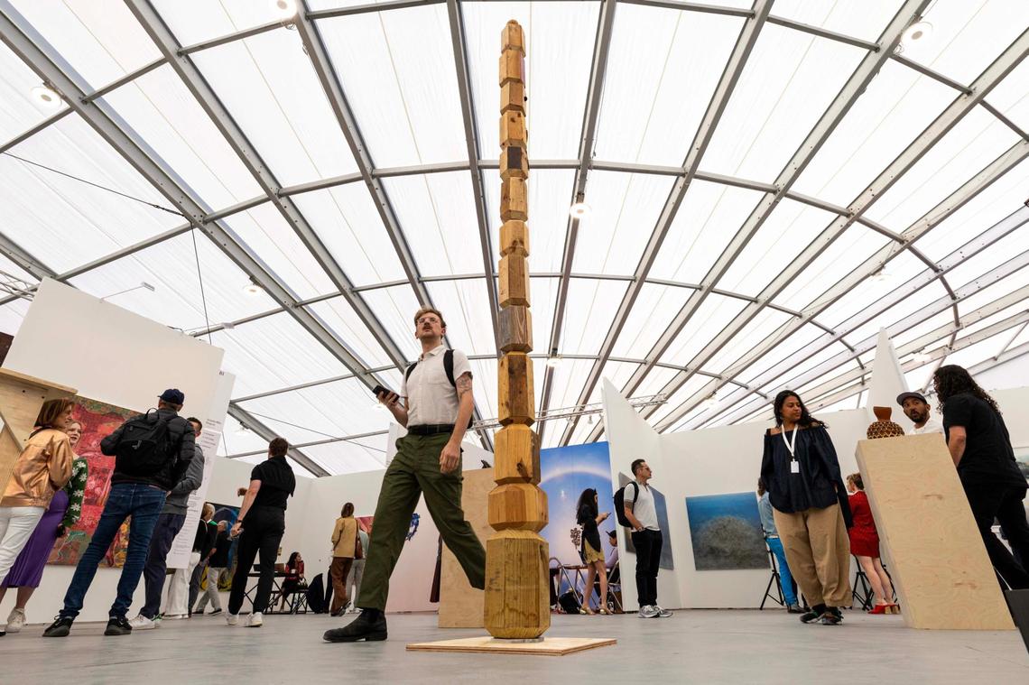 Guests walk around the tent at Untitled Art Fair on Tuesday, Dec. 3, 2024, in Miami Beach, Fla.