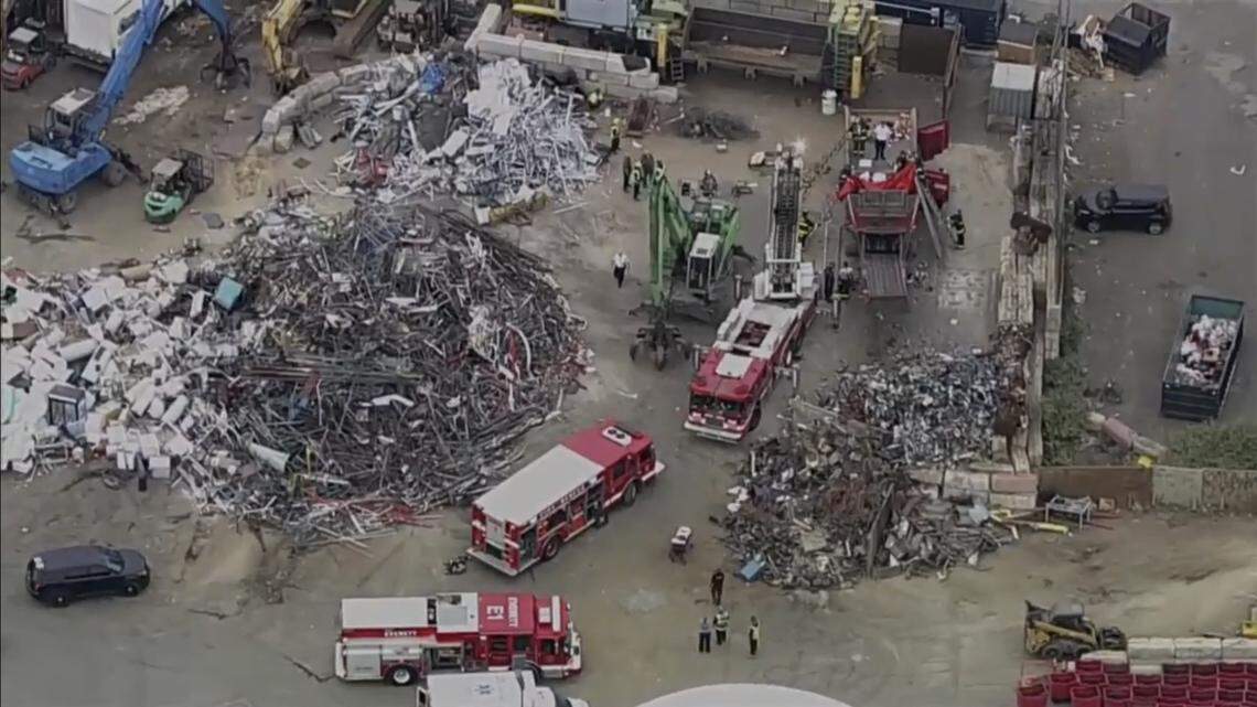 A scrapyard worker was trapped in a piece of machinery for hours before he was rescued, Massachusetts officials say.