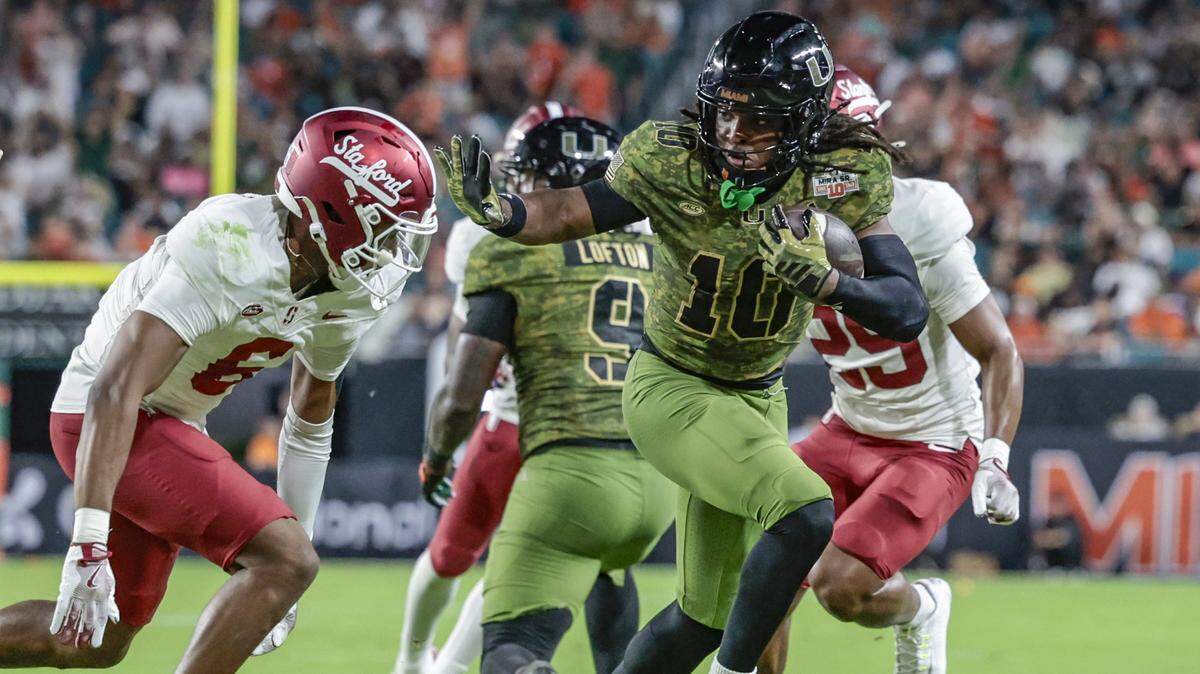 Miami Hurricanes wide receiver Malachi Toney (10) gains a first down as Stanford Cardinal cornerback Collin Wright (6) defends in the first half during their NCAA football game at Hard Rock Stadium in Miami Gardens, Florida, on Saturday, October 25, 2025.