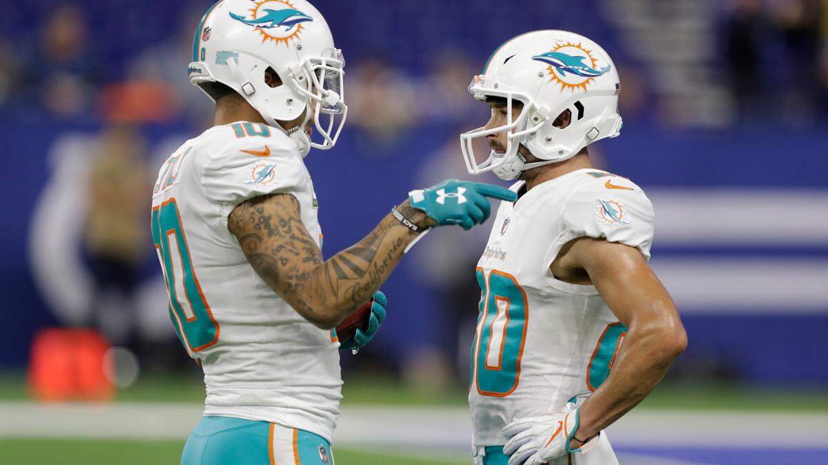 Miami Dolphins wide receiver Kenny Stills (10) talks with wide receiver Danny Amendola (80) before an NFL football game against the Indianapolis Colts in Indianapolis, Sunday, Nov. 25, 2018. (AP Photo/Darron Cummings)