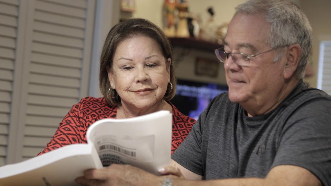 Elisa Perez and her husband, Horacio, look over a Medicare Advantage booklet in their home in Miami.  When Elisa Perez, a retired school principal, was ready to sign up for Medicare three years ago, she chose a Medicare Advantage plan that was comprehensive but relatively inexpensive.