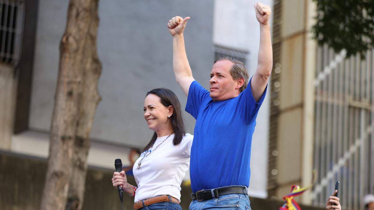 Former Deputy of the National Assembly of Venezuela, Juan Pablo Guanipa (R) gestures next to Venezuelan opposition leader Maria Corina Machado during a protest called by the opposition on the eve of the presidential inauguration in Caracas on January 9, 2025. Machado, who emerged from hiding to lead protests against the swearing-in of Nicolas Maduro for a highly controversial third term as president, was arrested after being “violently intercepted upon exiting the rally,” according to her security team.