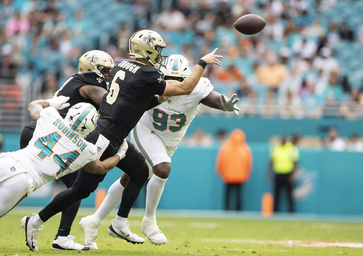 New Orleans Saints quarterback Tyler Shough (6) is tackled by Miami Dolphins linebacker Chop Robinson (44) in the first half of their NFL game at Hard Rock Stadium on Sunday, Nov. 30, 2025, in Miami Gardens, Fla.