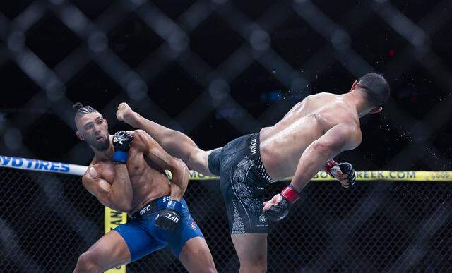 Dominick Reyes of the United States and Johnny Walker of Brazil fight in their light heavyweight bout at UFC 327 at the Kaseya Center on Saturday, April 11, 2026, in downtown Miami, Fla.