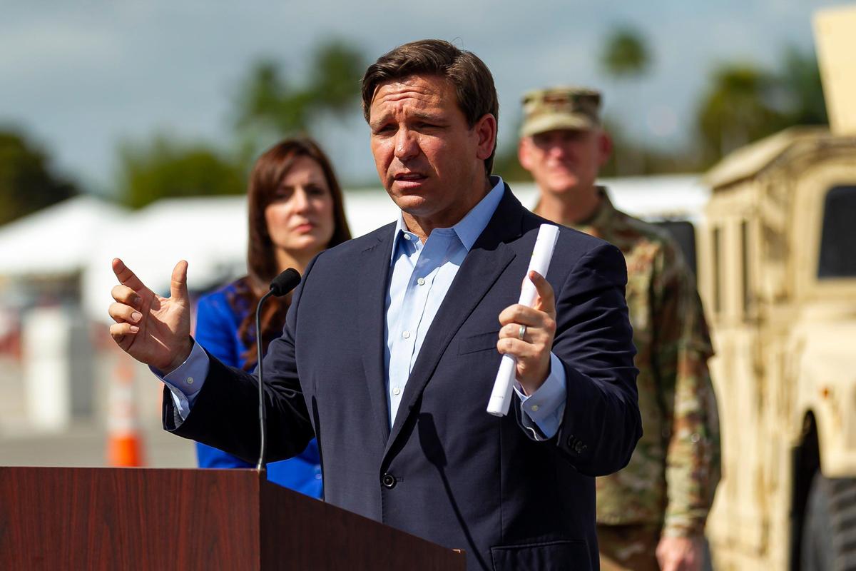 Florida Governor Ron DeSantis, center, speaks during a press conference at a COVID-19 testing center near a Hard Rock Stadium parking lot in Miami Gardens on Monday, March 30, 2020.