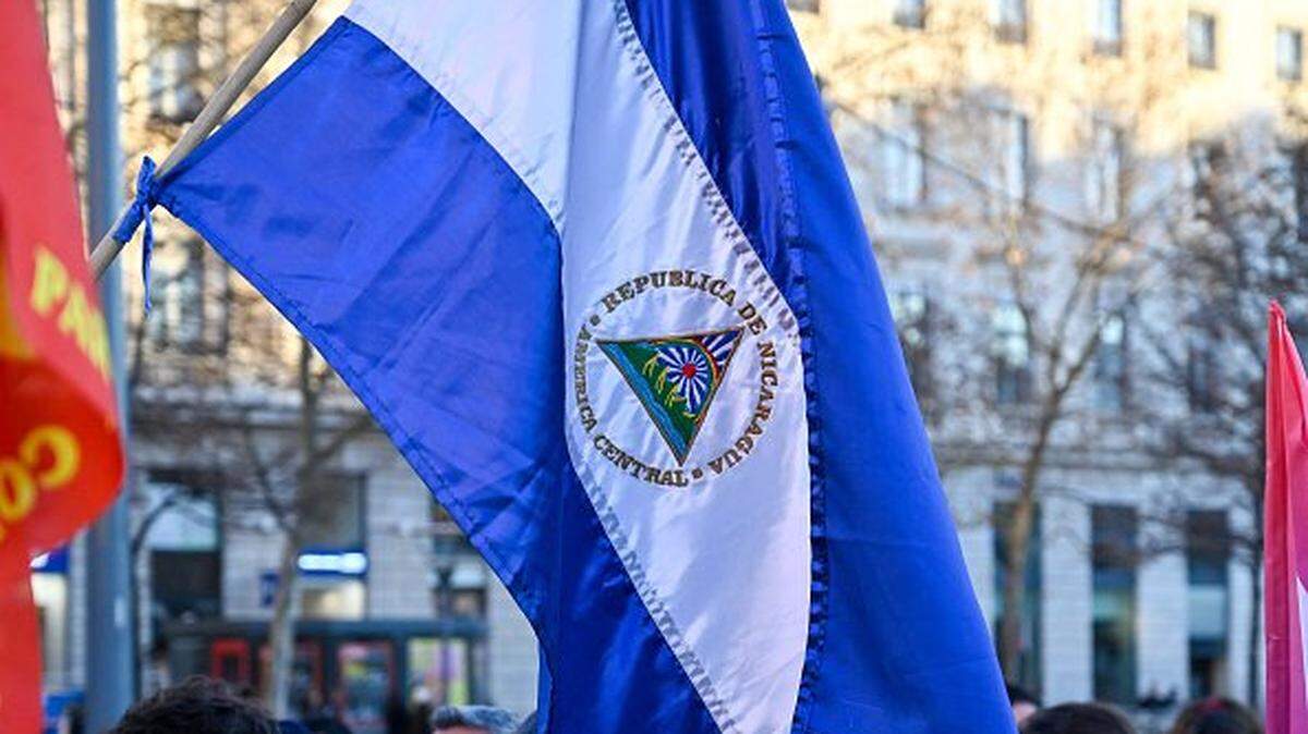 A Nicaraguan flag reading CENTRAL AMERICA REPUBLIC OF NICARAGUA flies in the wind during a rally in support of the Venezuelan people and against the aggression of US President Donald TRUMP toward Venezuela in Lyon in France on January 3 2026. (Photo by Matthieu Delaty / Hans Lucas / AFP via Getty Images)