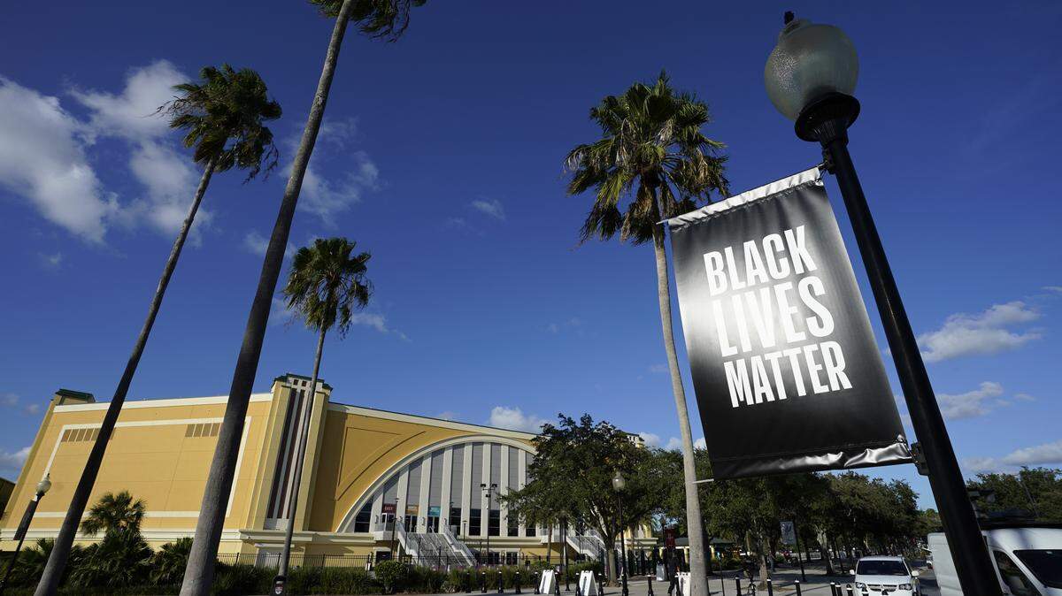 A Black Lives Matter banner hangs outside of the arena after a postponed NBA basketball first round playoff game between the Milwaukee Bucks and the Orlando Magic at AdventHealth Arena at ESPN Wide World Of Sports Complex on August 26, 2020 in Lake Buena Vista.