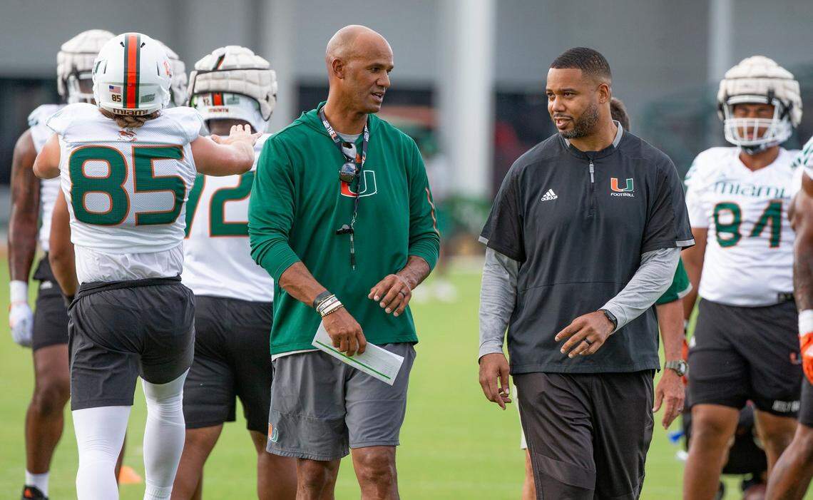 Former Miami Dolphin and Pro Football Hall of Famer Jason Taylor and defensive ends coach Rod Wright talk on the field during practice at Greentree Practice Field at the University of Miami in Coral Gables on Friday, August 5, 2022.