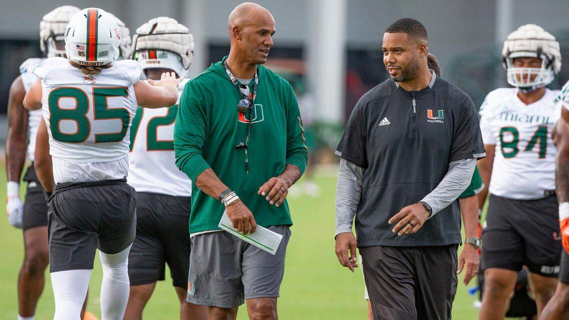 Former Miami Dolphin and Pro Football Hall of Famer Jason Taylor and defensive ends coach Rod Wright talk on the field during practice at Greentree Practice Field at the University of Miami in Coral Gables on Friday, August 5, 2022.