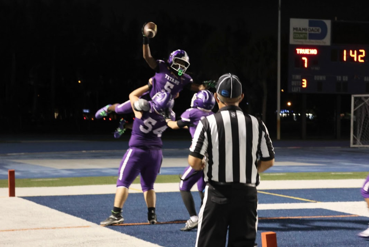 True North’s Cecil Smith celebrates after scoring a 27-yard touchdown run in the second quarter of the Titans’ 28-6 victory over Jacksonville University Christian on Thursday night at Tropical Park.