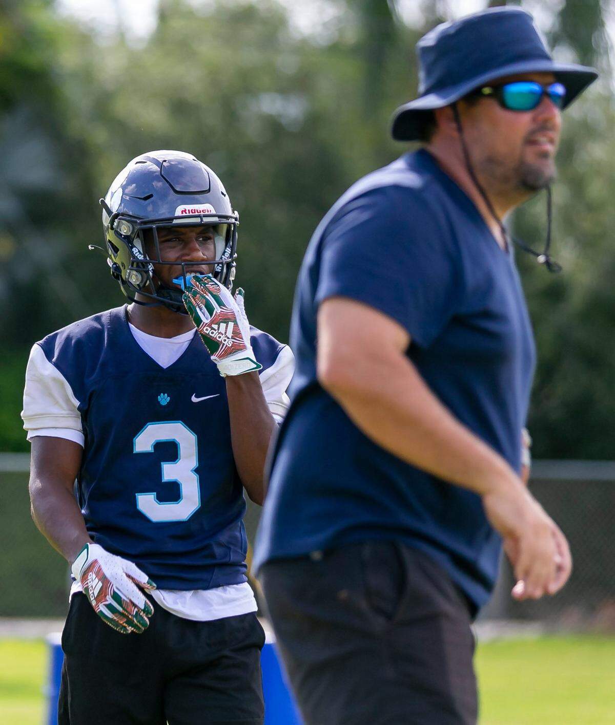 Miami Palmetto coach Mike Manasco supervises a drill during practice as senior wide receiver Derrick Bohler looks on.