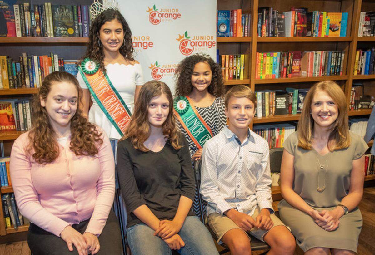 The 2018 Junior Orange Bowl Creative Writing Contest winners, their teachers, and two members of the Junior Orange Bowl Court celebrate at Books & Books.