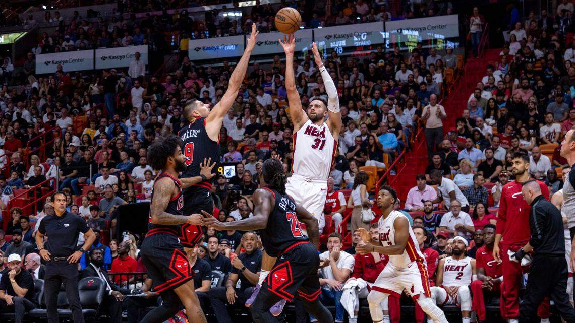 Miami Heat forward Max Strus(31) shoots a three-pointer over Chicago Bulls center Nikola Vucevic (9) during the fourth quarter of an NBA play-in tournament game at Kaseya Center in Downtown Miami, Florida, on Friday, April 14, 2023.