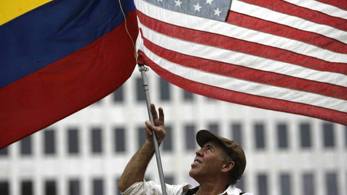 A man waves the Colombian and U.S. flags during an anti-FARC rally in Houston, Texas, in 2008