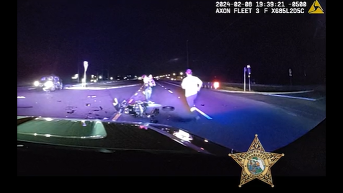 The deputy flagged down a driver stopped at the intersection and passed the safe child to him before going back for the trapped baby, footage showed.