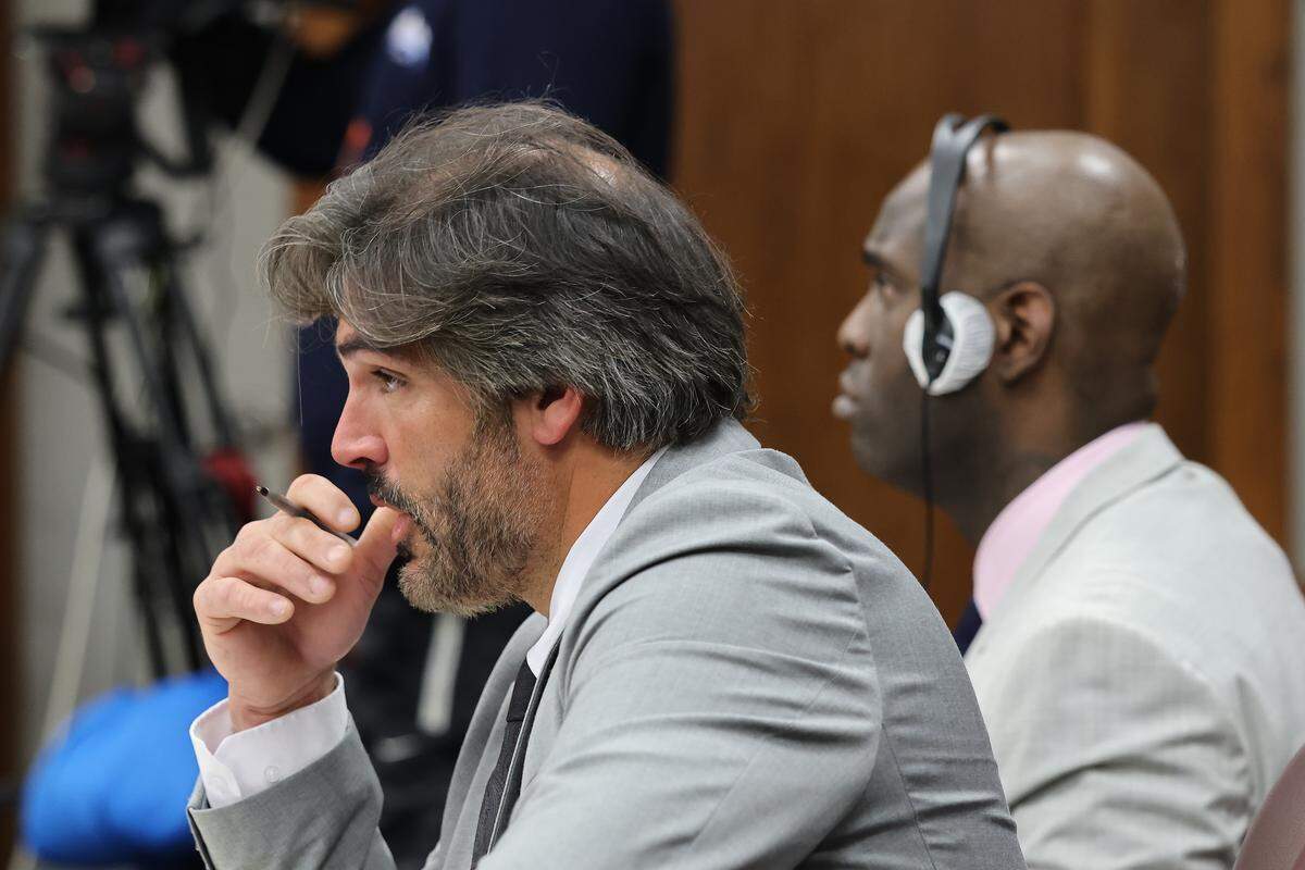 Cuban rapper Yosvanis “Chocolate MC” Sierra Hernandez sits next to his attorney Adolfo Gil during the first day of his trial for solicitation of first-degree murder as prosecutors presented their witness in Courtroom 7-4 at the Richard E. Gerstein Justice Building on Wednesday, November 12, 2025, in Miami, Florida. 