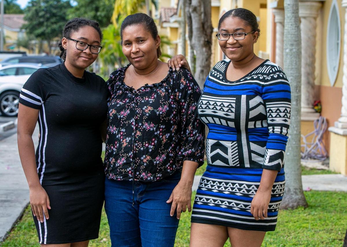 Bertha Osson with two of her daughters, Kiera, left, and Keonia Atis, at her home in Homestead.