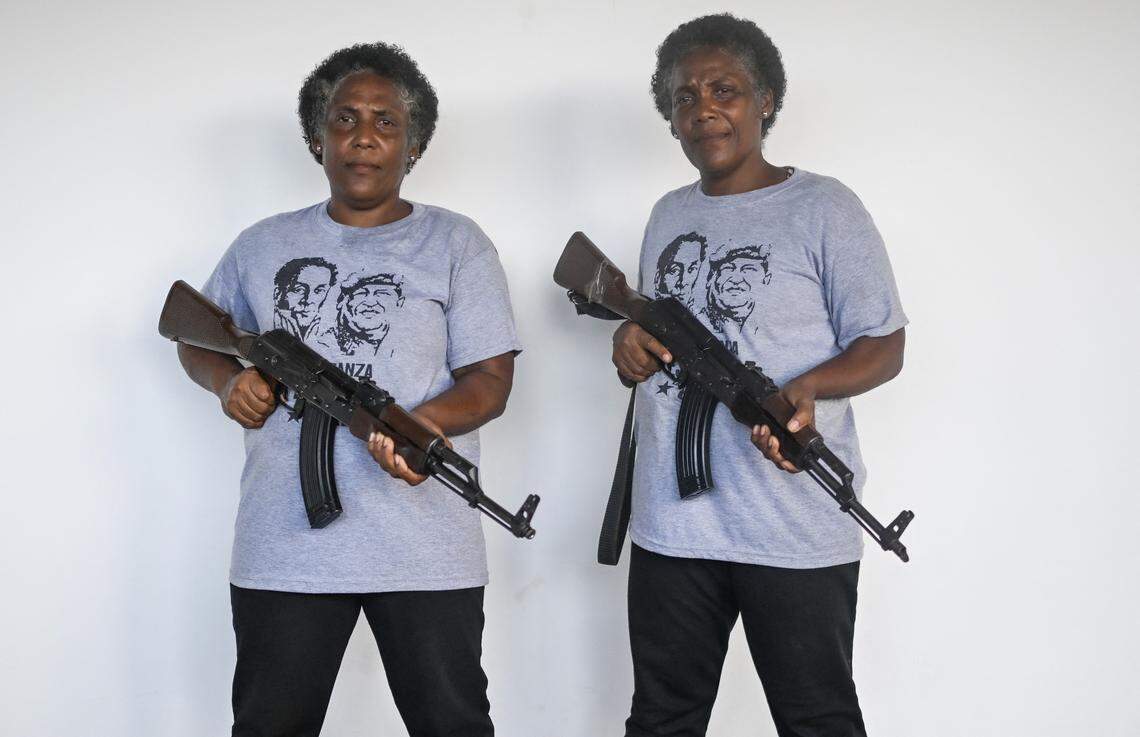 Two twin sisters, Carmen and Maria Santana, members of the Bolivarian Militia, hold rifles during a military training exercise in La Guaira, Venezuela, on Oct. 8, 2025.