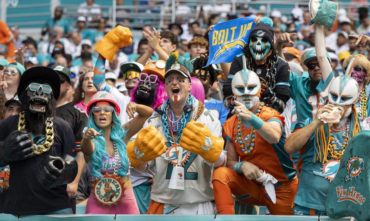 Miami Dolphins fans cheer as their team plays against the Los Angeles Chargers in the first half of their NFL game at Hard Rock Stadium on Sunday, Oct. 12, 2025, in Miami Gardens, Fla.