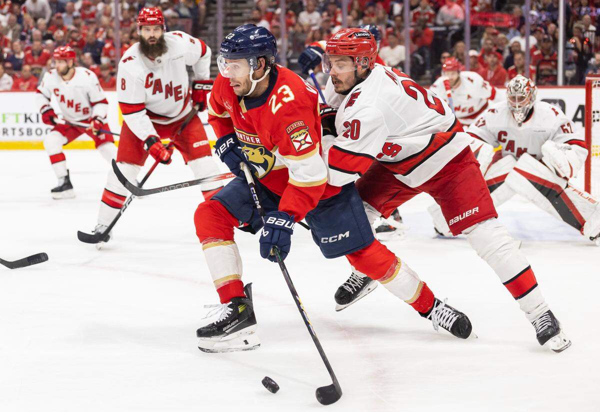 Florida Panthers center Carter Verhaeghe (23) skates with the puck as Carolina Hurricanes center Sebastian Aho (20) defends in the second period of Game 3 during the Eastern Conference final of the NHL Stanley Cup playoffs at Amerant Bank Arena on Saturday, May 24, 2025, in Sunrise, Fla.