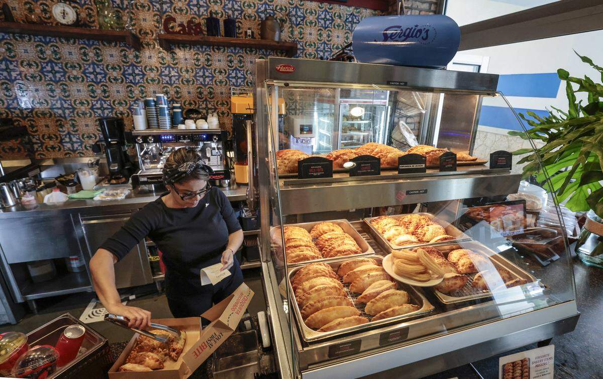 Ismaru Lara fills a box with pastries to go at Sergio's restaurant in Kendall. The local restaurant chain is celebrating it's 50th Anniversary in Miami, Florida, on Wednesday, September 24, 2025. 